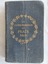 A miniature dark blue cloth covered New Testament of our Lord and Saviour Jesus Christ with a gold circular laurel wreath stamped on the front cover. 