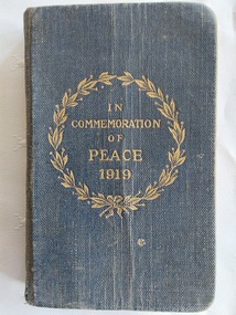 A miniature dark blue cloth covered New Testament of our Lord and Saviour Jesus Christ with a gold circular laurel wreath stamped on the front cover. 
