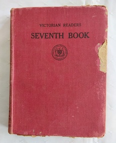 A damaged red cloth covered hardcover book with the title Victorian Reader Seventh Book, printed in black lettering at the top of the front cover.