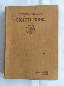 A tan cloth hardcover Victorian Readers Eighth Book, printed in black lettering at the top of the front cover.