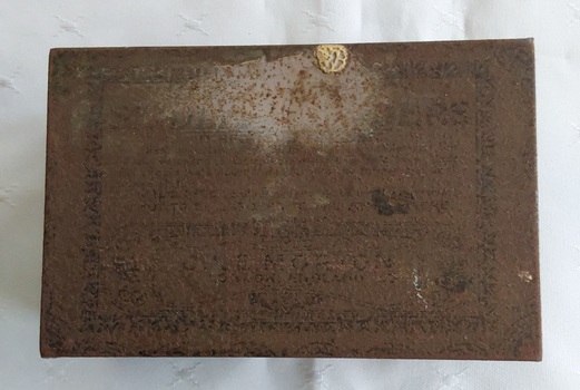 A rusty small metal empty vintage brown and black patterned rectangular lidded old tin which contained Seidlitz Powders. 