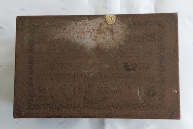 A rusty small metal empty vintage brown and black patterned rectangular lidded old tin which contained Seidlitz Powders. 