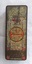 A rusty empty vintage small rectangular metal red and gold tin with faded branding on the lid. It contained Butter Scotch sweets. 