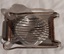 A stainless steel egg slicer with a base which has a raised stand or support with slats to hold the cooked, shelled egg.