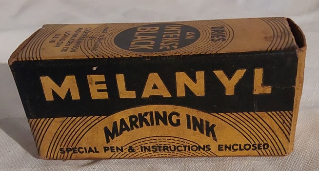 An empty yellow and black Melanyl Marking Ink cardboard box.