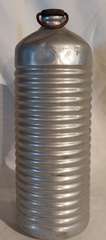 A medium sized vintage aluminium, cylindrical bed or foot warmer, with a removable brass screw stopper which has a wire looped handle on top.