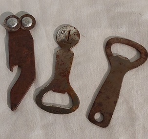 Three small rusted vintage metal bottle openers.