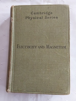 A light green cloth covered hardcover book titled, Electricity and Magnetism. 
