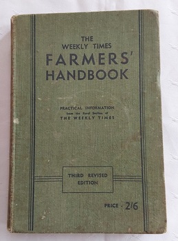 A green cloth hardcover book with the title printed in black text: The Weekly Times Farmers' Handbook on the front cover. 