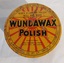 A flat round vintage Wundawax Furniture Polish tin with a removable lid and polish contents inside. 