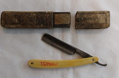 A vintage Tonso Cut Throat Shaving Razor with a cream bone handle.