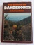 A book with a brown and colourful dust jacket featuring an autumn photograph of the countryside viewed from the Dandenong Ranges in Victoria. 