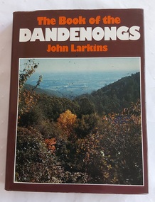 A book with a brown and colourful dust jacket featuring an autumn photograph of the countryside viewed from the Dandenong Ranges in Victoria. 
