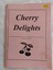 A small pink covered Cherry Delights recipe book with the title printed in black and a few cherries drawn below.