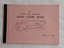 A small rectangular pink covered home made Soup Cook Book with the title and an illustration of a bowl of soup with vegetables around it.