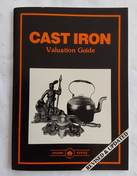 A small black covered book with the title printed in orange lettering and a photograph of cast iron including a statue and a kettle. 