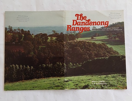 A book with a colourful double cover photograph of the Dandenong Ranges in Victoria. 