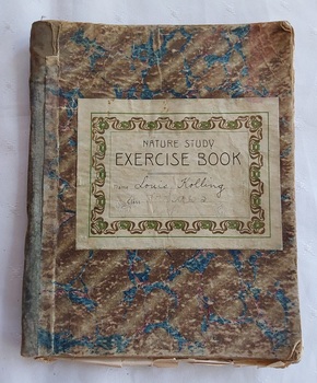 A badly worn brown and blue marbled style coloured covered Nature Study Exercise book for student use in schools. 