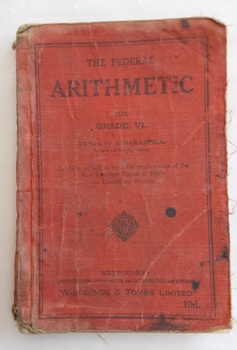 A red covered Arithmetic book for Grade VI with the title, editor and publisher details enclosed by a border of black lines at the edges of the front cover. 