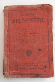 A red covered Arithmetic book for Grade VI with the title, editor and publisher details enclosed by a border of black lines at the edges of the front cover. 