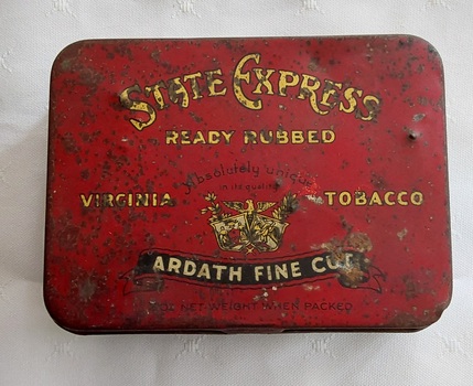 A red rectangular, State Express cigarette tin with a hinged lid. 