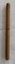 A vintage wooden turned two piece treen needle case with six rusted steel knitting needles.