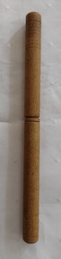 A vintage wooden turned two piece treen needle case with six rusted steel knitting needles.