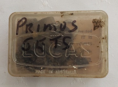 A small lidded plastic container with Primus Jet parts, washers, jet nipples, tiny open cylinders and a tiny screw.