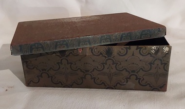 A rusty small metal empty vintage brown and black patterned rectangular lidded old tin which contained Seidlitz Powders. 