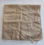 A small square beige silk scarf with machine stitched edges and a 100% cotton tag.
