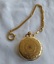 A gold Classique pocket watch with a white enamel dial, roman numerals a 'seconds' dial inset into the main dial.
