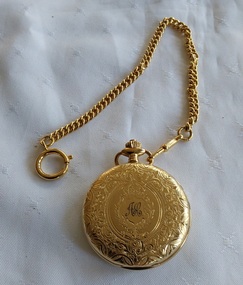 A gold Classique pocket watch with a white enamel dial, roman numerals a 'seconds' dial inset into the main dial.