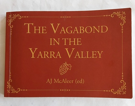 A small tan rectangular book with the title printed in yellow at the top, an outline of a bunch of grapes and the editor's name below. 