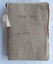 An old red cloth soft covered music book with a homemade brown paper cover.