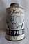 A small cylindrical tin of Dr Harley's Reg. Foot Powder with a small screw top lid.