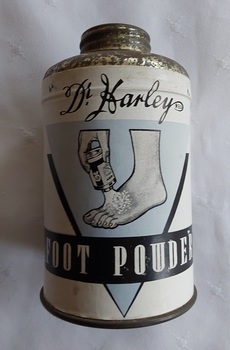 A small cylindrical tin of Dr Harley's Reg. Foot Powder with a small screw top lid.