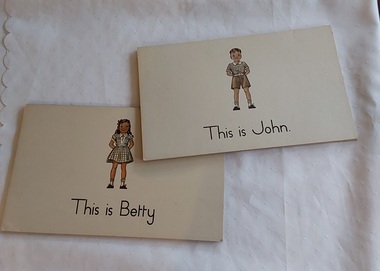 22 large thick 'flashcards' with sentences and coloured illustrations to match the 1950's primary school reader John and Betty. 