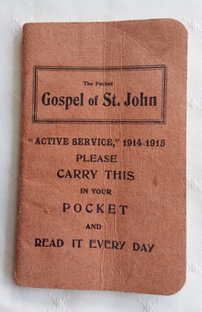 This faded red "Active Service" 1914-1915, The Pocket Gospel of St. John is a tiny, specialized scripture booklet distributed to British and Commonwealth troops during WW1.