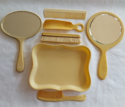 Seven antique pieces of an art deco bedroom vanity set made from celluloid or Ivory Celluloid to appear ivory like. 