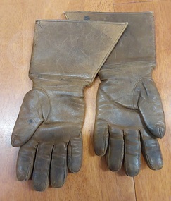 A pair of brown fur lined WW11 Luftwaffe flying gauntlets tapered at the wrist, and fitted with a narrow expandable wristband. 