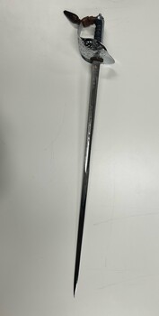 Full side view of sword, showing blade, hilt and knot