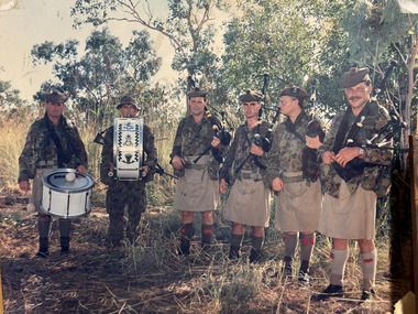 Photograph - Pipes and Drums soldiers in the field in older version of the DPCU