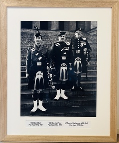 Photograph - Framed Photograph: Three Generations of Pipe Majors from the 5th Battalion (the Victorian Scottish Regiment) and 5th/6th Battalion (the Royal Victoria Regiment) Pipes and Drums c.1970s, Three Generations of Pipe Majors from the 5th Battalion (the Victorian Scottish Regiment) and 5th/6th Battalion (the Royal Victoria Regiment) Pipes and Drums c.1970s