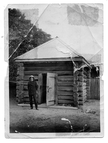 Photograph of Constable Albert Clement Theobald in front of a log lockup, Constable Albert Clements Theobald in front of a log lockup, circa 1913 to 1930