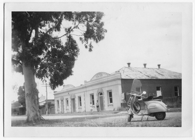 Photograph of a motor scooter and two people outside the Victoria Hotel and Theatre, Tarnagulla, Motor scooter and two people outside the Victoria Hotel and Theatre, Tarnagulla, c.1960s