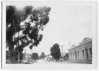 Photograph of motor scooter and two people outside the Victoria Hotel and Theatre, Tarnagulla, Motor scooter and two people outside the Victoria Hotel and Theatre, Tarnagulla, c.1960s