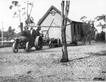 Photograph of wooden building being moved by traction engine, Wooden building being moved by traction engine, c.1893 (original image)