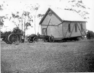 Photograph of wooden building being moved by traction engine, Wooden building being moved by traction engine, c.1893 (original image)