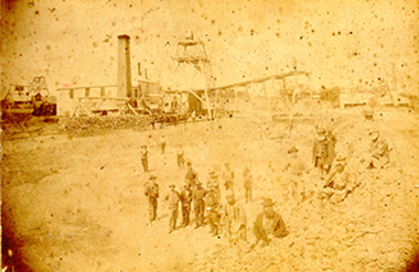 Photograph: Workers gathered at Prince Of Wales and Old Poverty Co's main shaft in January 1886, 1886