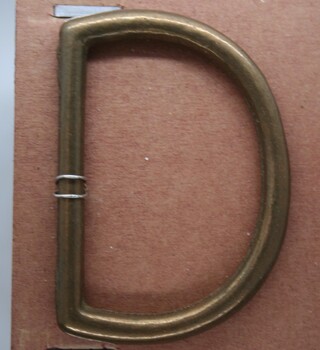 Brass D ring used as horse accessory